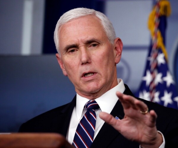 pence in a black suit and navy blue striped tie