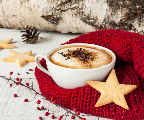 cup of coffee with star cookies, red blanket