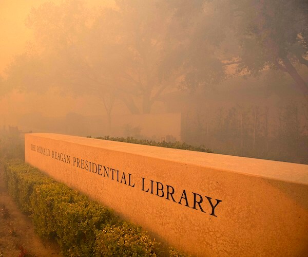 Smoke engulfs the sign for the Ronald Reagan Library during a brush fire