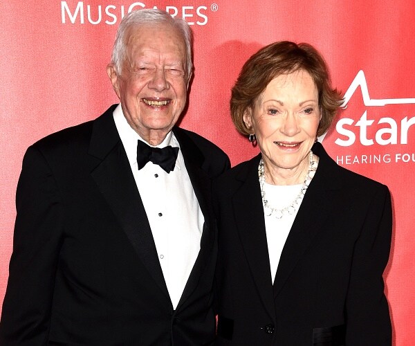 jimmy and rosalynn carter stand on carpet