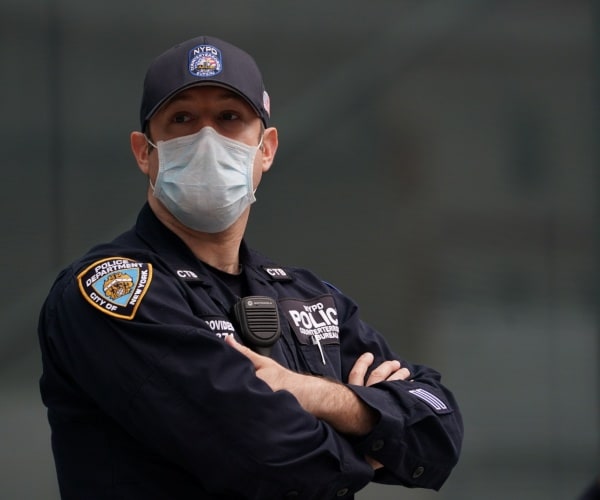 nypd officer in uniform wearing a face mask