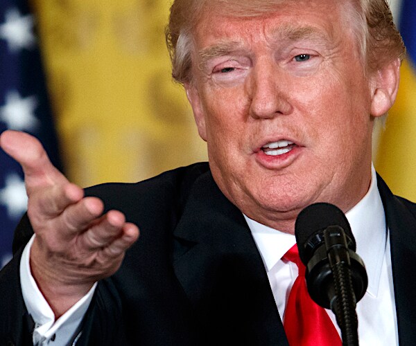 president donald trump points his left hand forward at the media during a contentious news conference