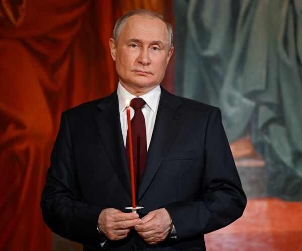 vladimir putin holds a candle