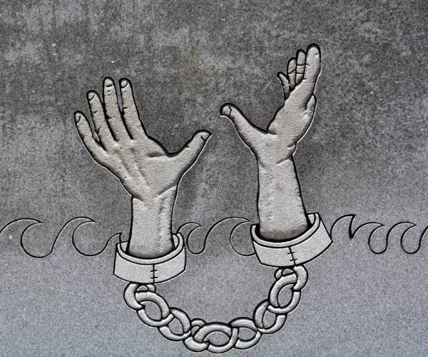 hands in shackles lifting upward