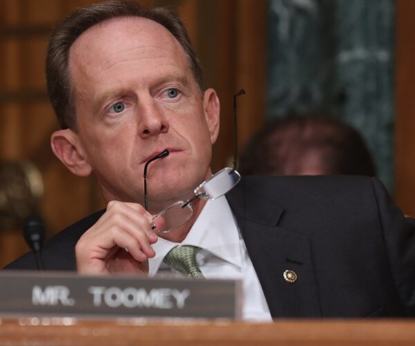 pat toomey listens at a hearing