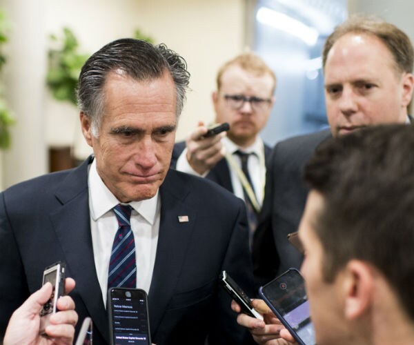 sen. mitt romney speaking to reporters in the capitol