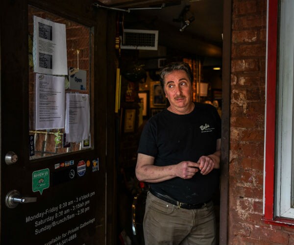 a man is shown standing in the doorway of his restaurant business in atlanta