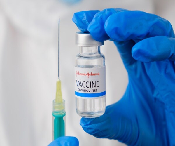 a vial of Johnson & Johnson covid vaccine and a syringe