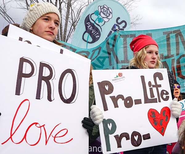 Girls holding signs advocate for life and love during the annual March for Life