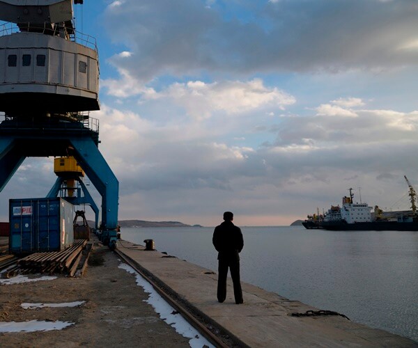 a man looks out to rajin harbor in north korea,near the borders of china and russia