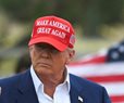 Man wearing a red baseball cap that reads Make America Great Again