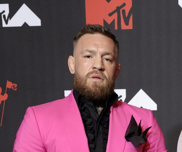 conor mcgregor stands on red carpet