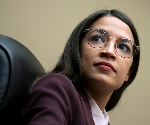 rep. alexandria ocasio-cortez listens at a hearing