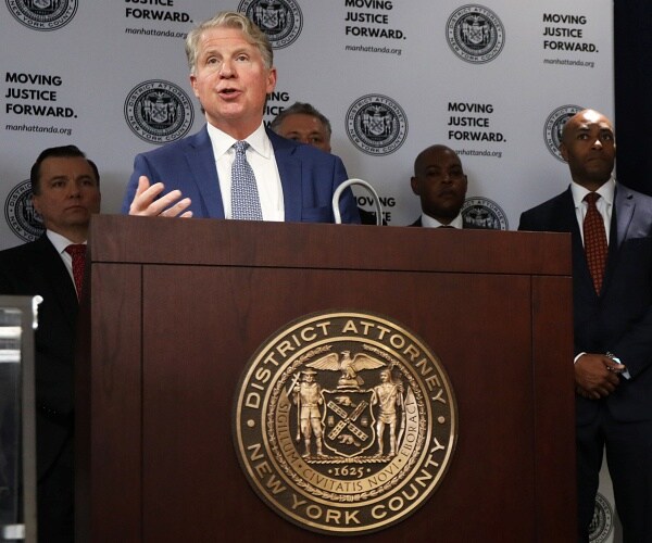 cyrus vance jr stands behind podium