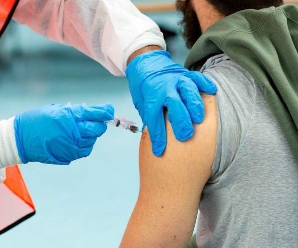 man receives coronavirus vaccine