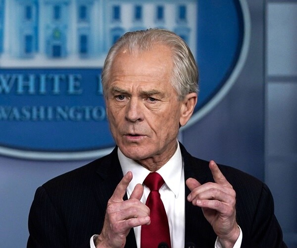 peter navarro stands at the podium and speaks with the press