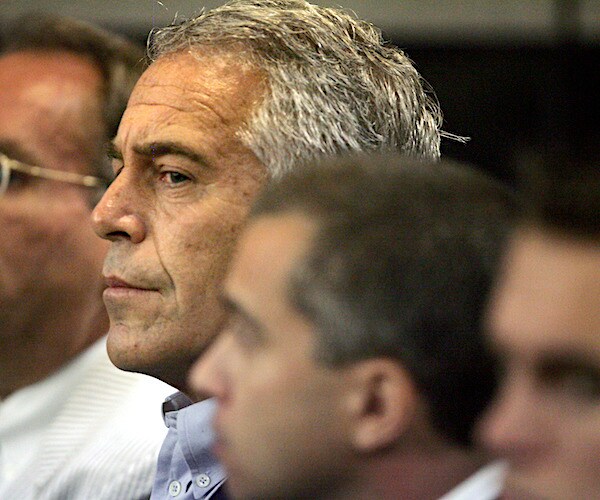 jeffrey epstein sits between two men during a court hearing before he committed suicide