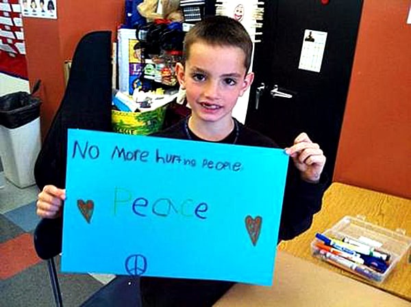 Young Marathon Victim’s Sign: ‘No More Hurting People’