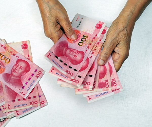 chinese senior woman counting paper money for payment 

