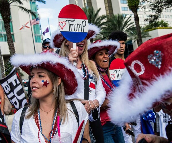 supporters of former president donald trump await his arrival in orlando florida
