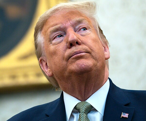 president donald trump looks in pensively from the oval office