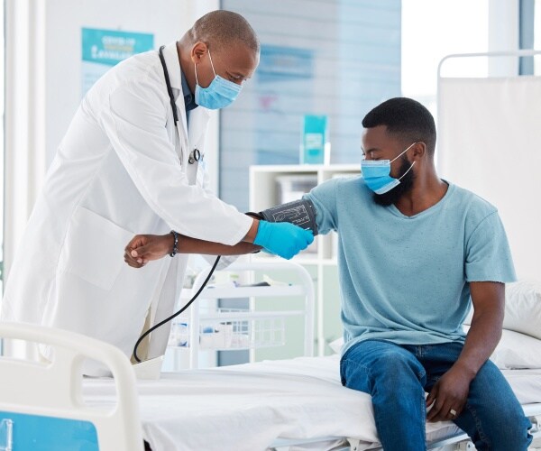 a doctor using a sphygmomanometer for consultation in a clinic