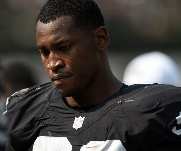 aldon smith stands on football field