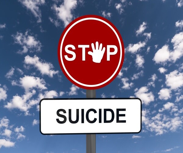 a stop sign that says "stop suicide" 