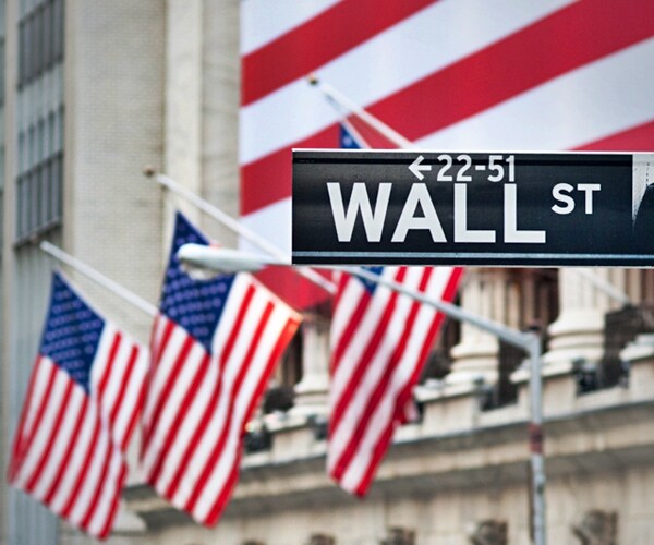 wall street sign amid american flags