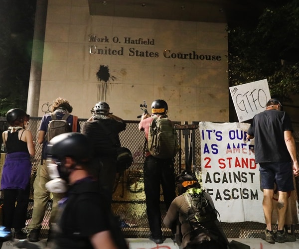 protesters spraypaint on the mark o. hatfield courthouse in portland