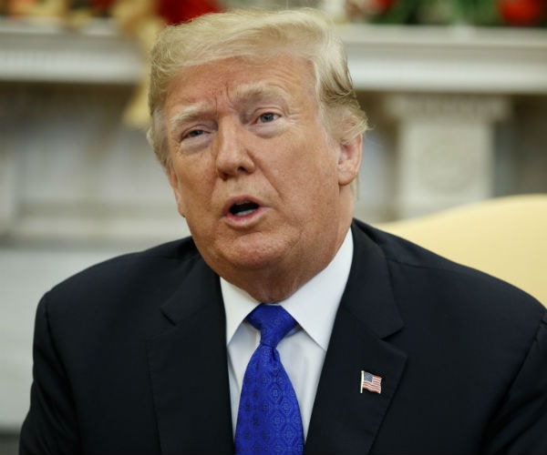 president donald trump speaks to reporters at the oval office