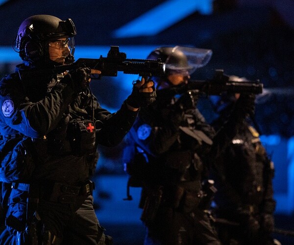 portland police point weapons at protesters