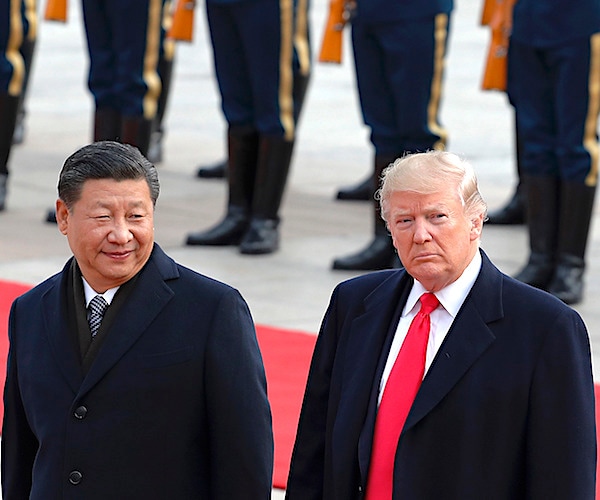 chinese president xi jinping and president donald trump walk off the red carpet before a summit