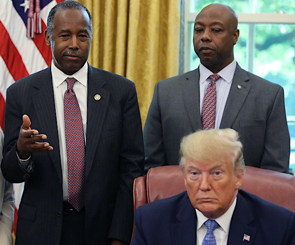 ben carson and tim scott stand behind donald trump during news conference