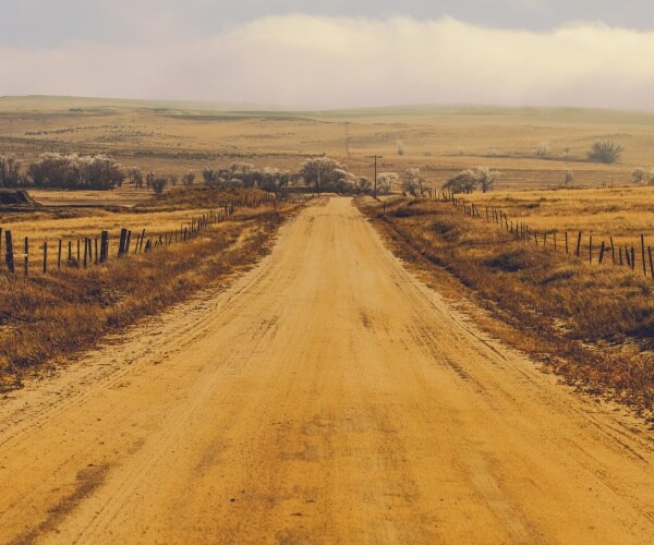 long dirt road in countryside