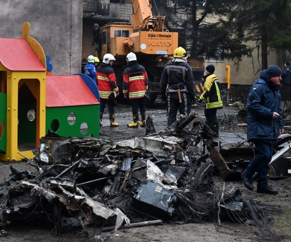 firefighters work near a crash site