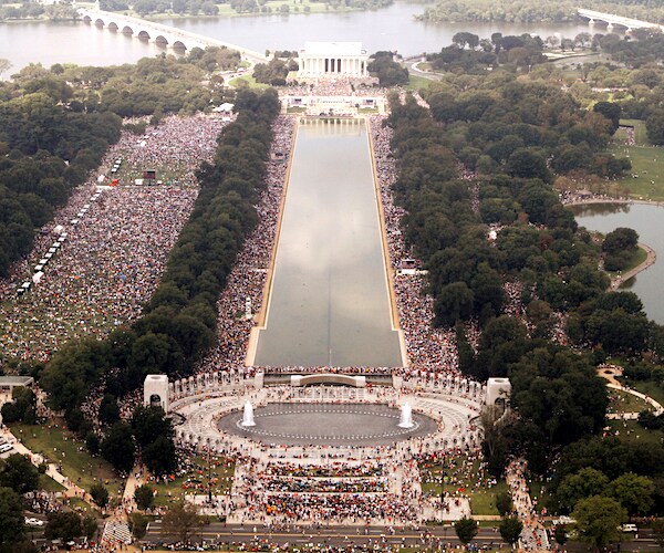 a rally swarms the reflecting pool and the lincoln memorial in washington