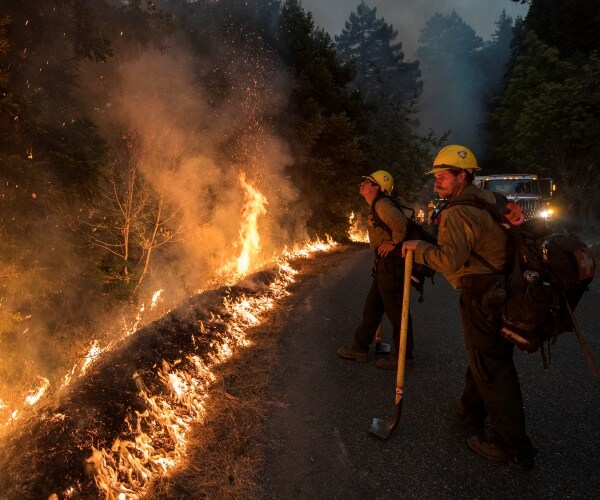 firefighters monitor a controlled burn