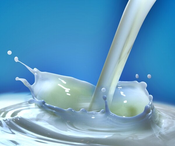 milk splash on blue background 