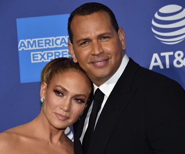 jennifer lopez and alex rodriguez stand on red carpet