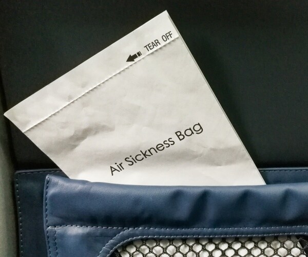 air sickness bag in pocket of airplane seat