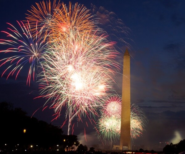 fireworks over washington monument in the evening