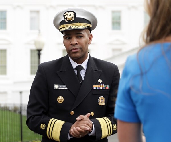 surgeon general jerome adams pauses to speak with reporters outside the white house