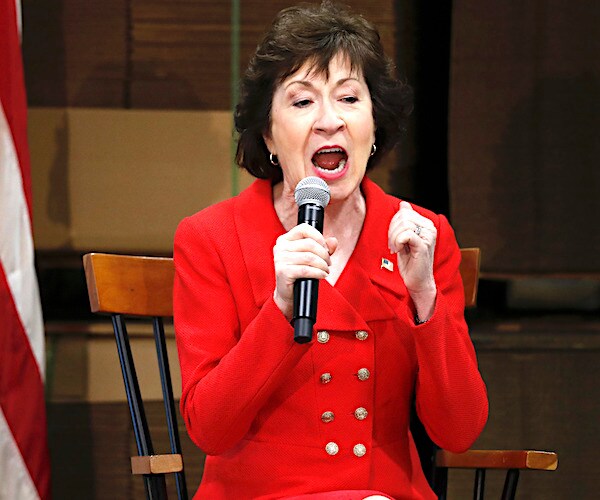 susan collins exults into a mic during a speech