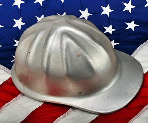 construction hard hat on the american flag. 