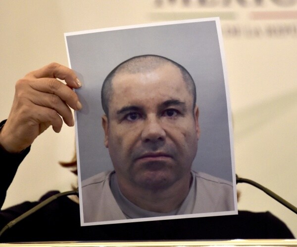 mexican ag holds up picture of el chapo