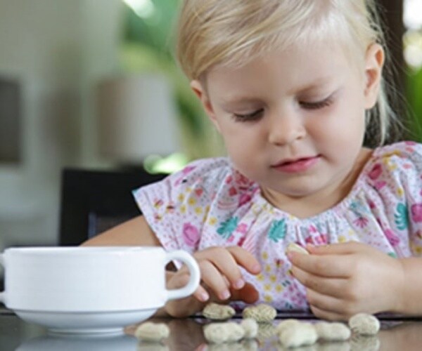 young girls eating peanuts