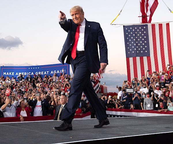 president donald trump points to the rally crowd in his first rally after his covid-19 recovery