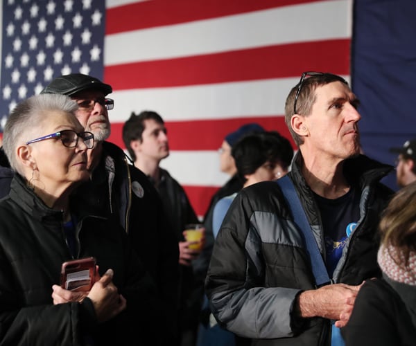 supporters of senator bernie sanders wait for iowa caucuses results to post