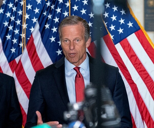 john thune speaks into mic at press conference